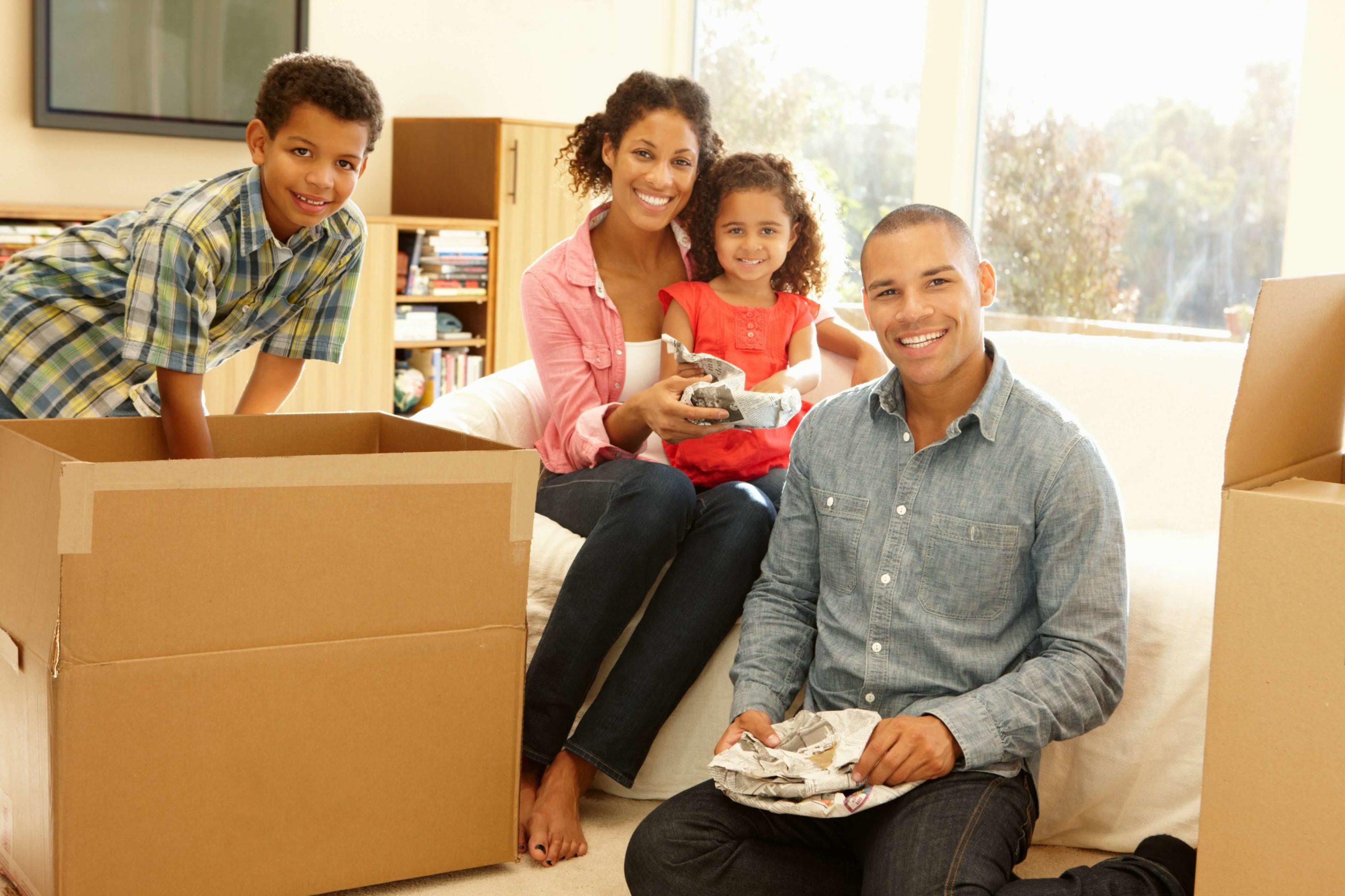 Happy Mixed race family moving in new home